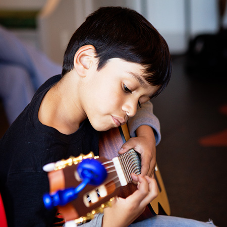Boy Playing The Guitar