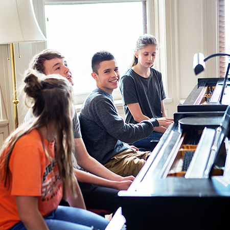 students playing piano together