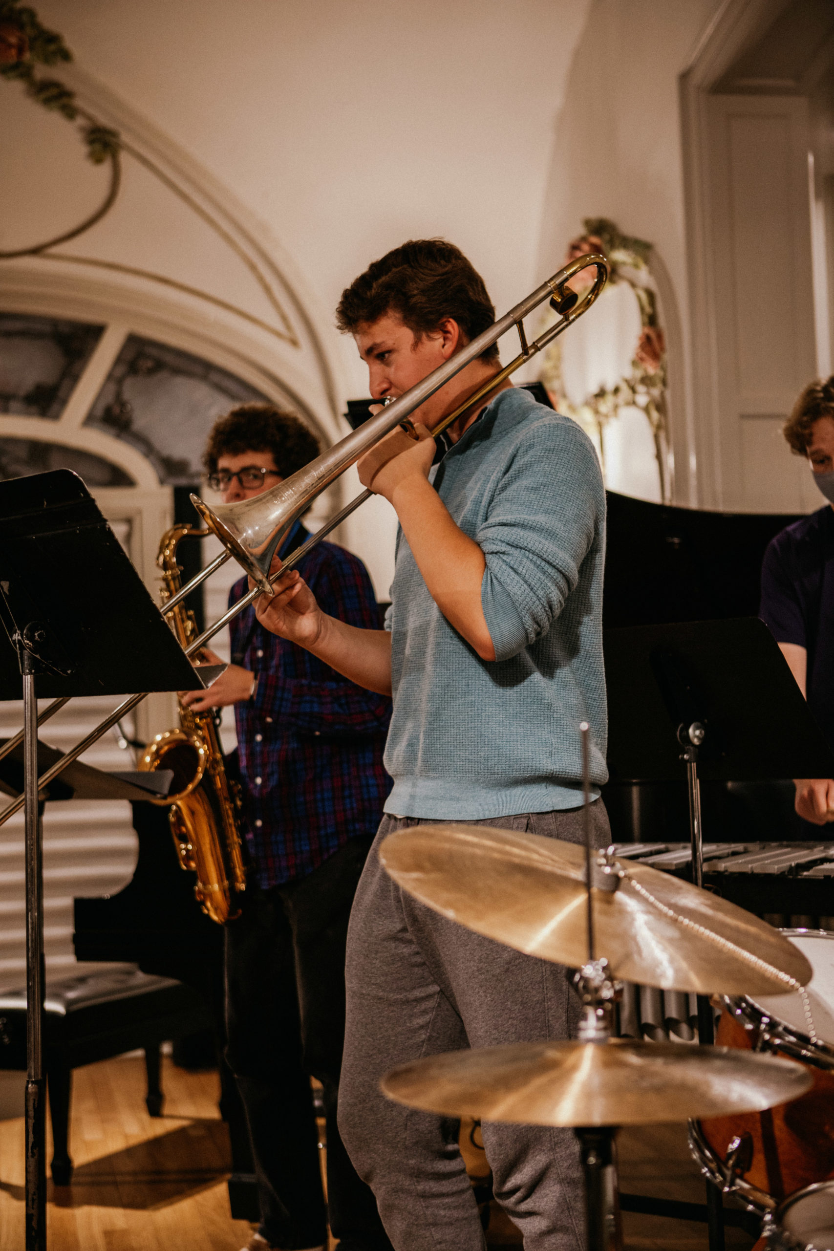 teen boy playing trombone on stage